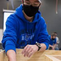 A student sets a robot on the course